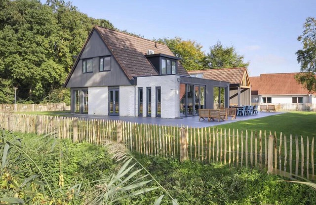 Luxury 12-person villa with canal view, 6 bedrooms, 3 bathrooms, fenced garden and designer kitchen at Holiday Park ’t Hooge Holt.