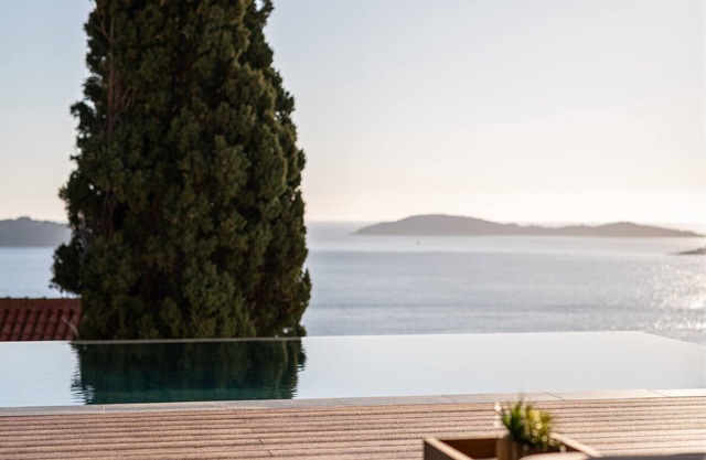 Luxury sea view villa with a heated infinity pool and a stunning sunset