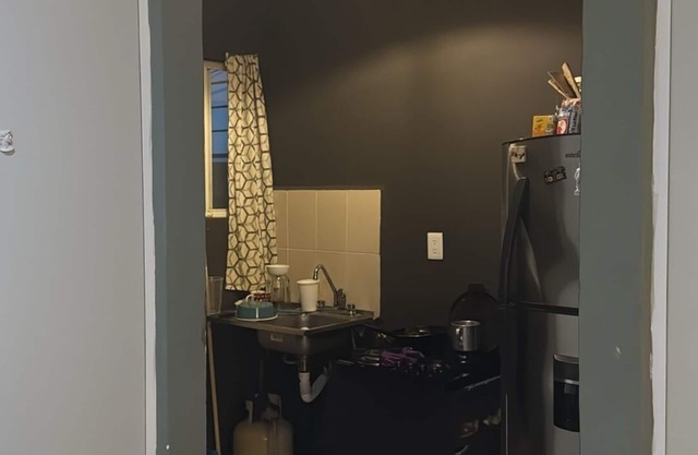 MiniHouse in front of park with parking.