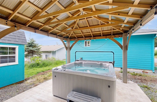 Modern Beach Cottage with a covered patio, fire pit, grill, & easy beach access