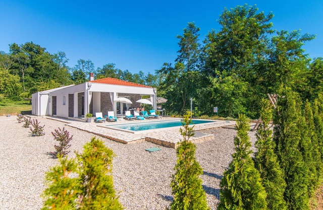 Modern villa with swimming pool and fenced garden