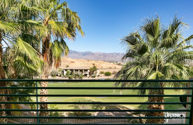 Perfectly refined home w/large balcony, overlooking lake and palms.