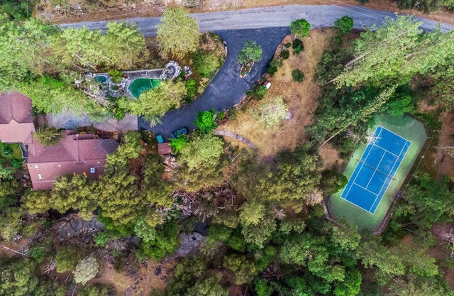 PRIVATE RESORT STYLE RIVERFRONT ESTATE W/TENNIS COURT, POOL, SPA, WATERFALLS.