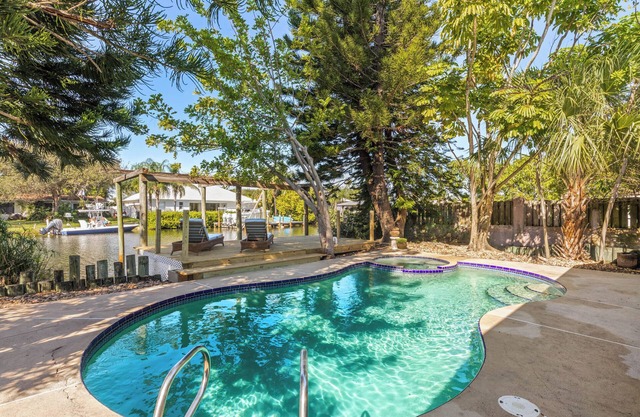 Private wooded 3BR/3BA house w/heated pool on canal just steps from beach