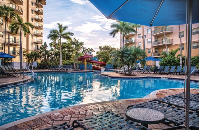 Relax at our Palm Tree secluded Resort with a poolside bar and waterslide