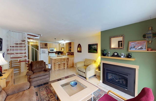 Renovated condo with mountain views, fireplace & spiral staircase - walk to lift