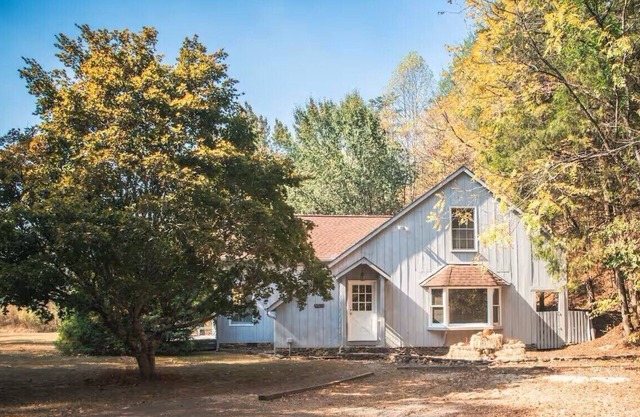 Spacious 4-bedroom farmhouse with 20 acres surrounded by a whitewater creek.