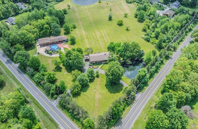Spacious 5-bedroom lodge on 35 acres with pool house, pool, 2 ponds, waterfall!