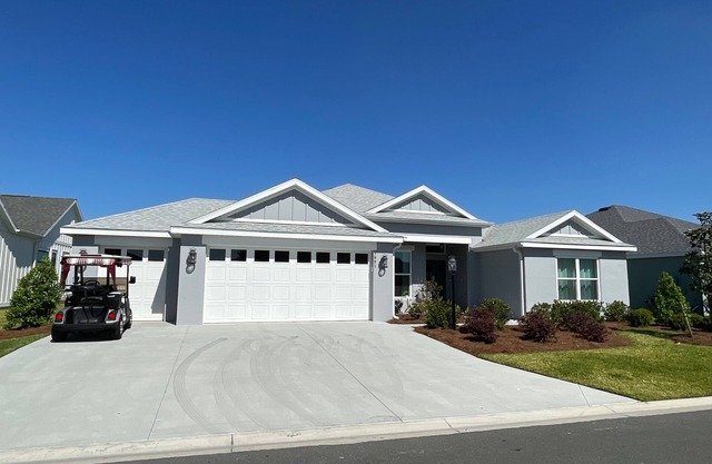 Stunning new home with water view, screened lanai & golf cart!