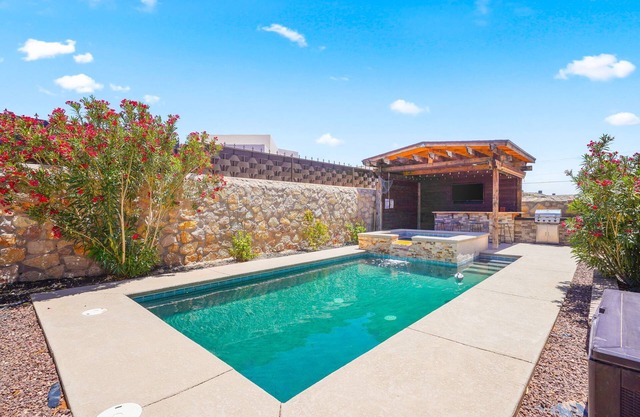 This is a true retreat in El Paso with a sparkling pool (w heater), hot tub, and full outdoor entertaining area with a 55" smart TV, tiki bar, and grill.