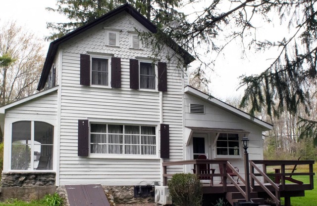 This lovely farmhouse is set back in the woods, just a short walk from the lake
