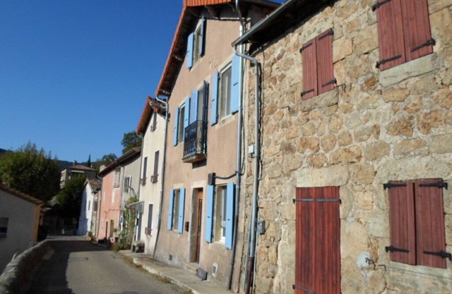 Traditional blue-shuttered stone house in a stunning Ardeche mountain village.