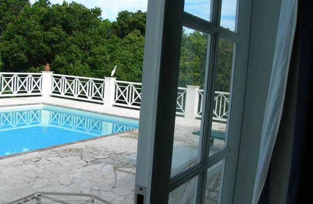 Villa with large pool, screened terrace overlooking Caribbean.