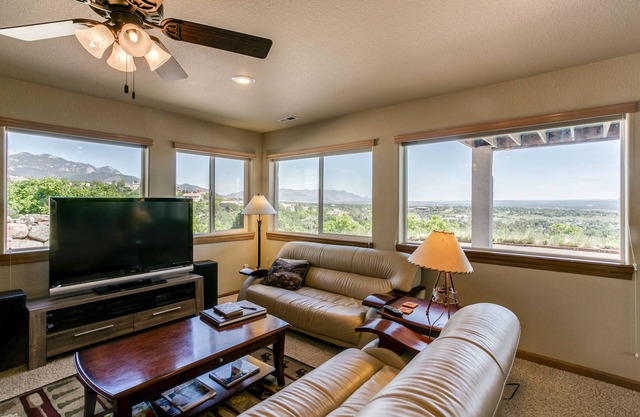 WALLS OF GLASS! Mountain top apartment, panoramic mt. views and city lights.
