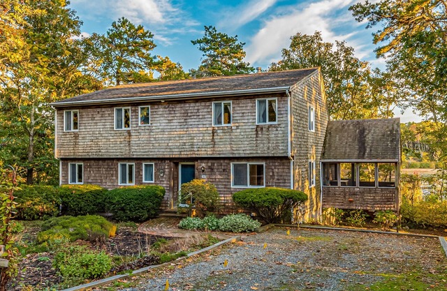Waterfront home with lovely lake views, great deck, sun porch & fireplace