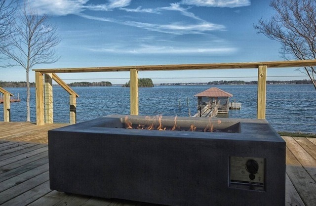 WATERFRONT W/AMAZING OPEN WATER VIEW, BOAT DOCK W/SEATING, DECK WITH FIREPIT