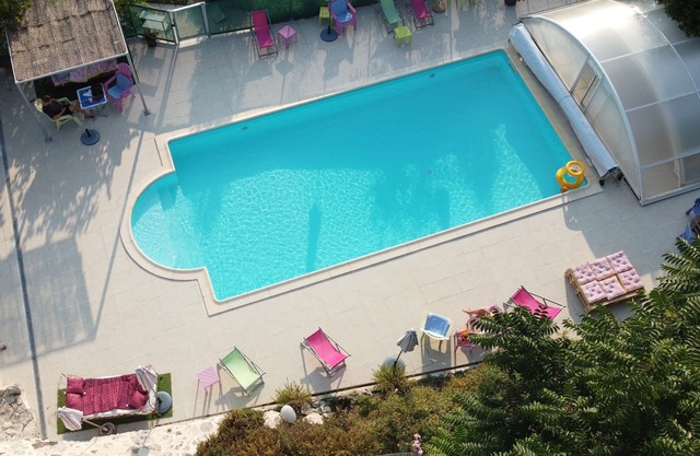 white stone cottage very well restored, surrounded by nature, with swimming pool
