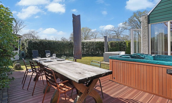 Ouddorp House | A cozy 4-person holiday home at De Klepperstee in Ouddorp by the Sea, featuring a lush garden, full privacy, and a private jacuzzi – all within walking distance of the beach.