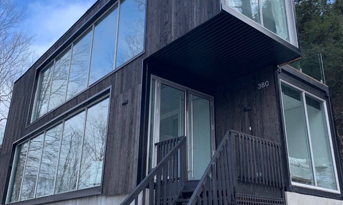Lac Superieur Village Ski Chalet | Architectural home with panoramic mountain views.