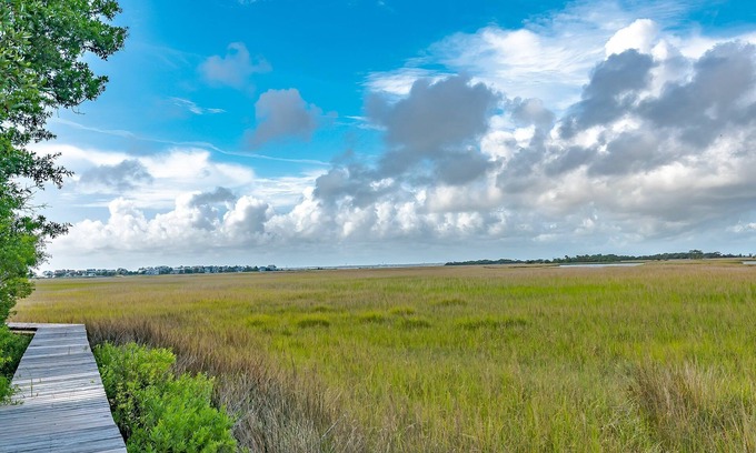 Bald Head Island Condo | As you enter, the Bald Head Creek and marsh vistas-through the walls of windows-catch your eye.