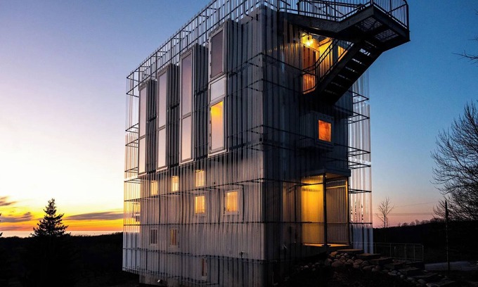 Northport House | Award-winning 9-level Chameleon House in Leelanau County. A modern-industrial masterpiece with reflective siding, rooftop deck, and epic Lake Michigan views near beaches and Fishtown.