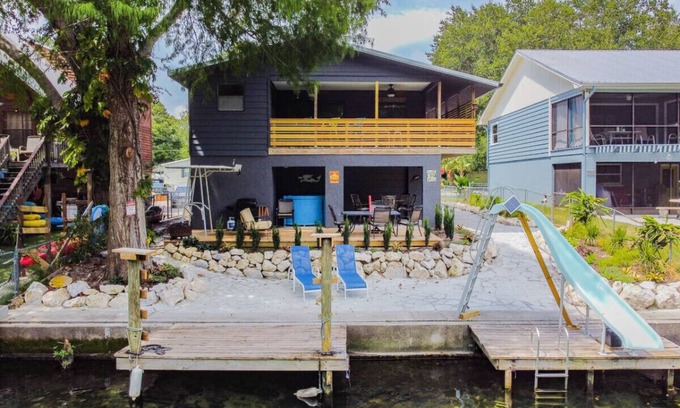 Weeki Wachee Gardens Apartment | Beautiful Weeki Wachee river house with kayaks, slide, and river views