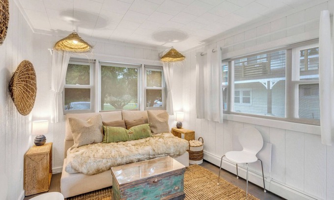 Montauk House | Bohemian-style hotel unit with ample natural light, a cozy seating area,.