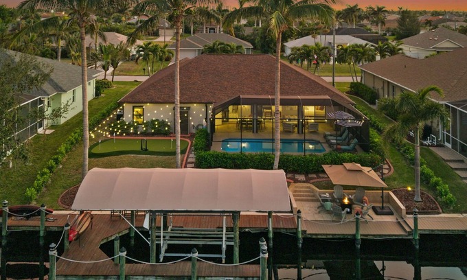 Pelican Villa | Canal-Front Oasis: Pool, Games, EV Charger