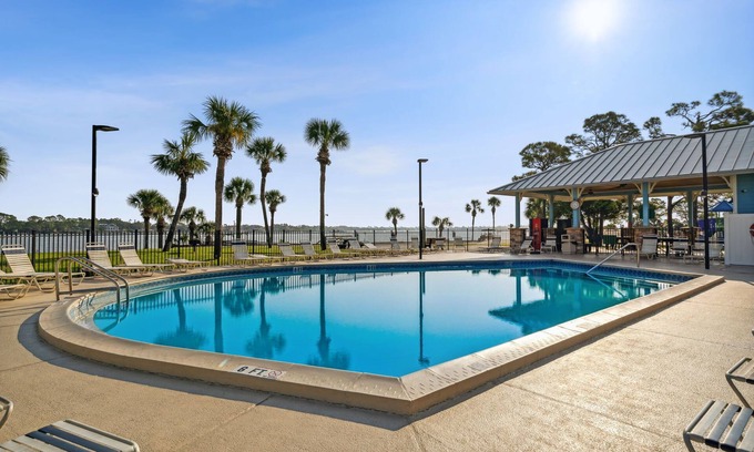Lower Grand Lagoon Cottage | Cozy family vacation in Panama City Beach with golf cart ,private beach, pools