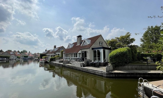 Langweer House | Cozy holiday home on the water with a terrace and jetty