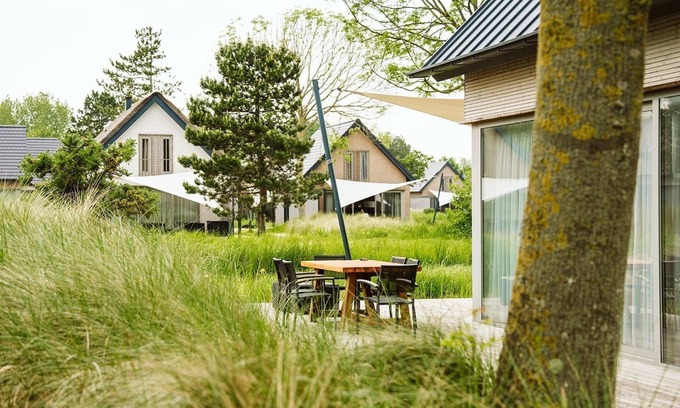 Ouddorp Resort | Enjoy all the extras of this vacation home, such as the wood-burning fireplace, wine refrigerator, and sun shower