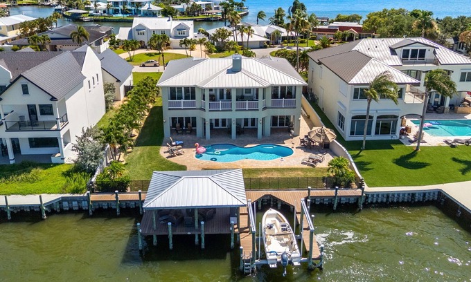 Cocoa Isles Country Club House | Gorgeous Direct Riverfront Pool Home W/Private Balcony, Movie Room, & Fire Pit!