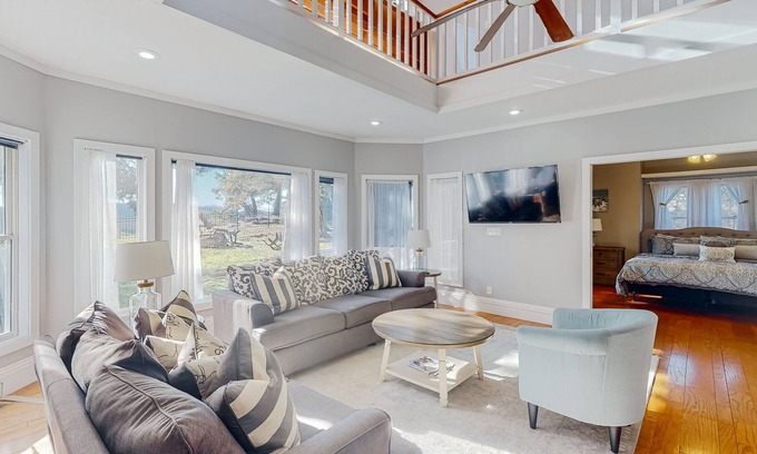 Holiday Island House | Gorgeous water view home with a fireplace, outdoor space & central AC