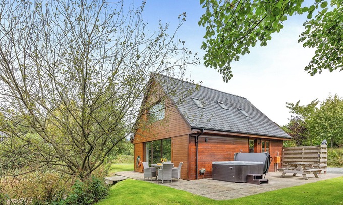 Menai Bridge Ski Chalet | Ground floor: Spacious open plan lounge, kitchen, dining area with log burner.