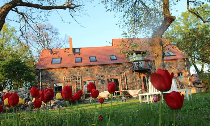 Klosterdorf House | Lovingly restored fieldstone barn with fireplace and woodchip heating.