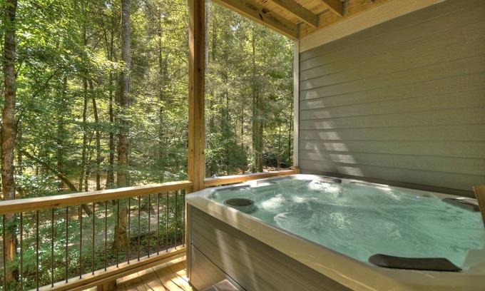 Ellijay Cabin | Lullaby Creek is pet friendly with a creek front setting, very private, hot tub, firepit, WIFi and fishing