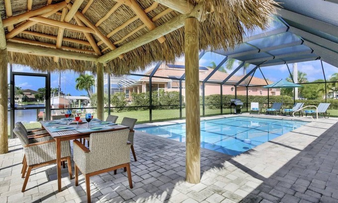 Pelican House | Luxury Gulf Access Pool Home With Large Tiki Hut Close to Tarpon Point Marina