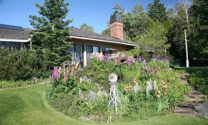 Charlevoix House | Luxury Lakefront Property with private dock, tennis court, trails & views