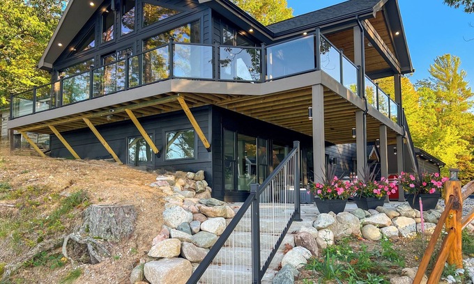 Kalkaska House | Luxury Scenic Lakeside Haven: Kayaks, Fire Pit, Multi-Deck, Game Room, Dock