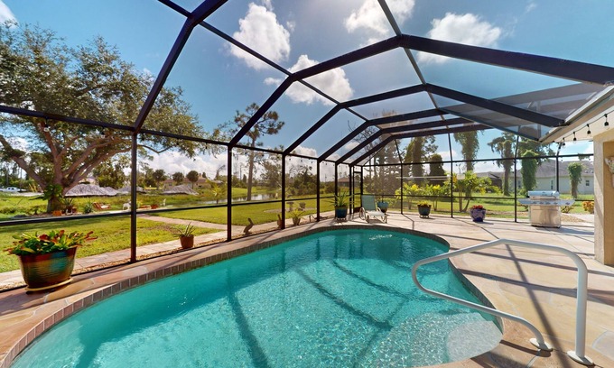 Long Meadow House | Nautical charmer on the canal with heated pool, sunny lanai, grill, W/D, and AC