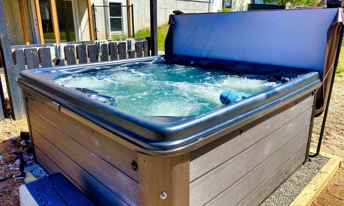 Grawn House | Pet-friendly home with fenced-in yard and hot tub