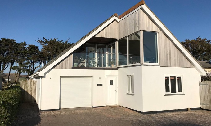 Trevone House | Polcarrek contemporary holiday home with parking and garden. Balcony with rural views