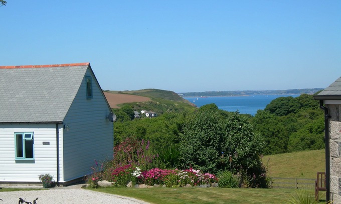 Helford Passage Cottage | Quirky luxury chalet-style cottage, beautiful sea views across a wooded valley