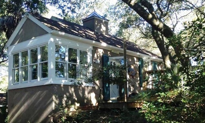 Folly Beach Cottage | Romantic, cozy cottage nestled amongst live oaks & palms, a block from beach.