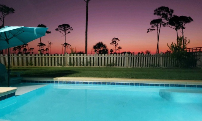 Port St. Joe House | Summer Bay, a beautiful Bay View Home private backyard oasis around the swimming pool, screened porch, and sundeck