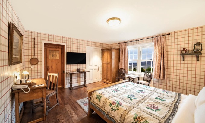 Shiel Bridge Bed & Breakfast | The wooden floors, vintage furniture, and tartan accents create a comfy room