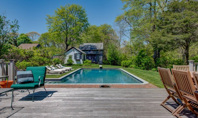 Quogue House | Traditional-style home with private pool, several sitting rooms, back deck,...