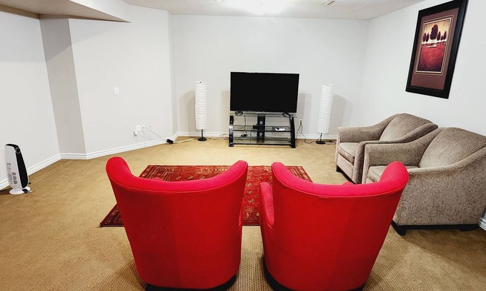 Airdrie House | Unique full basement suite with spacious living room.