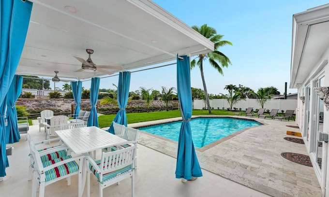 Golfview Harbor House | Waterfront Tropic Oasis: Heated Pool, Pergola, Canal, Dock, Air Hockey!