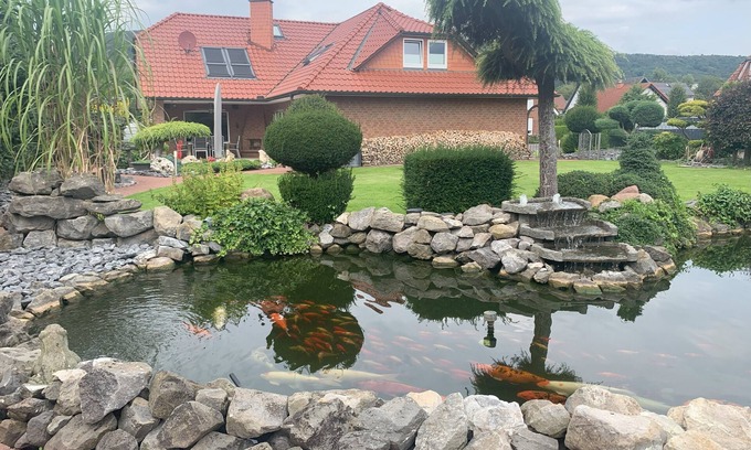 Rinteln House | Wesergarten vacation home with fireplace, large garden and well-kept fish pond